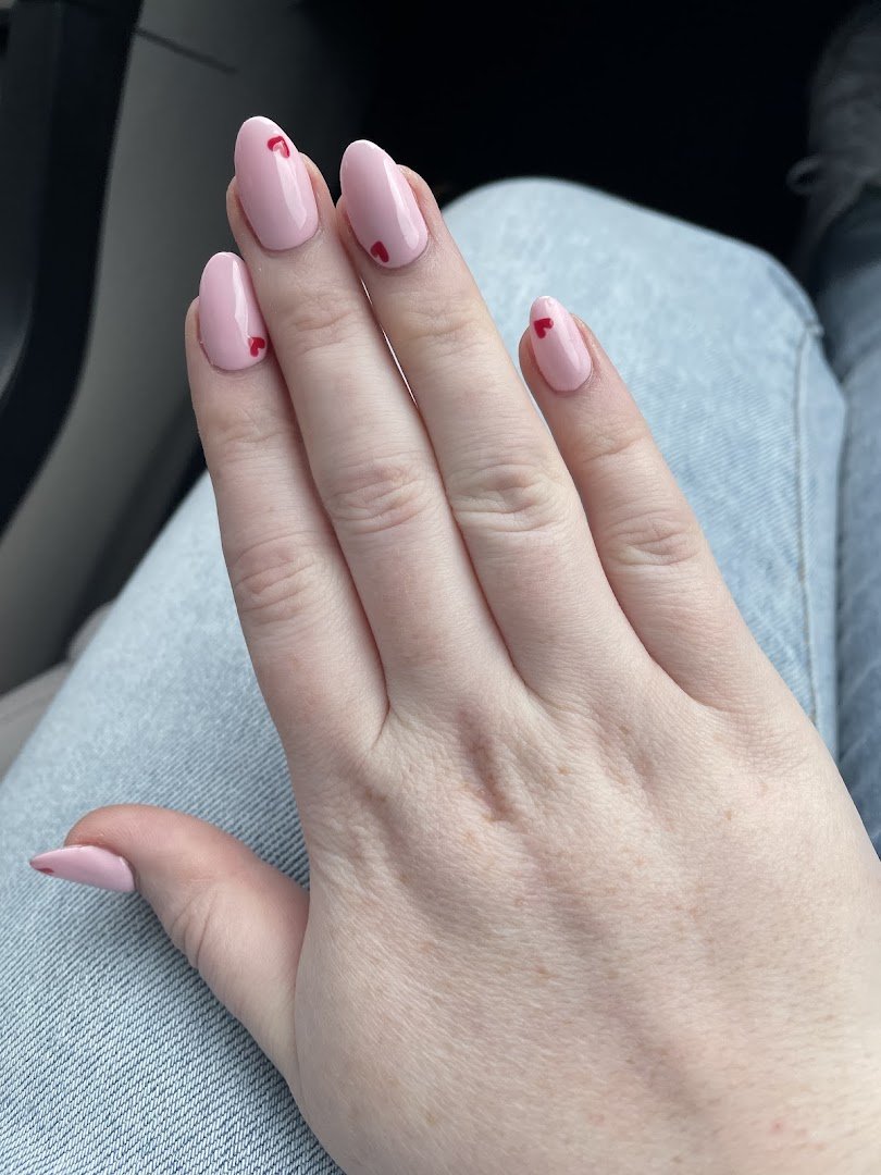 Manicured nails with glossy polish and fine nail art.