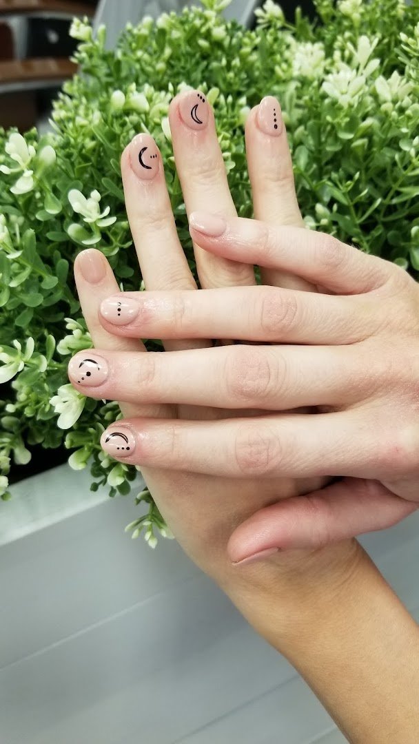 Manicured nails with glossy polish and fine nail art.